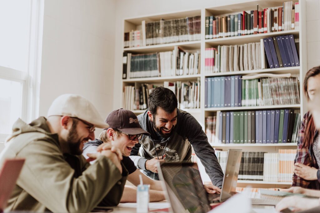 People at a table with computers and books, Publishing, Photo by Priscilla Du Preez on Unsplash