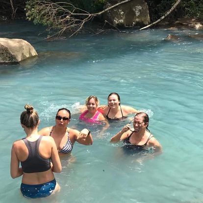 Costa Rica's Rio Celeste, Travel author Nikki Page swimming with Taya Page