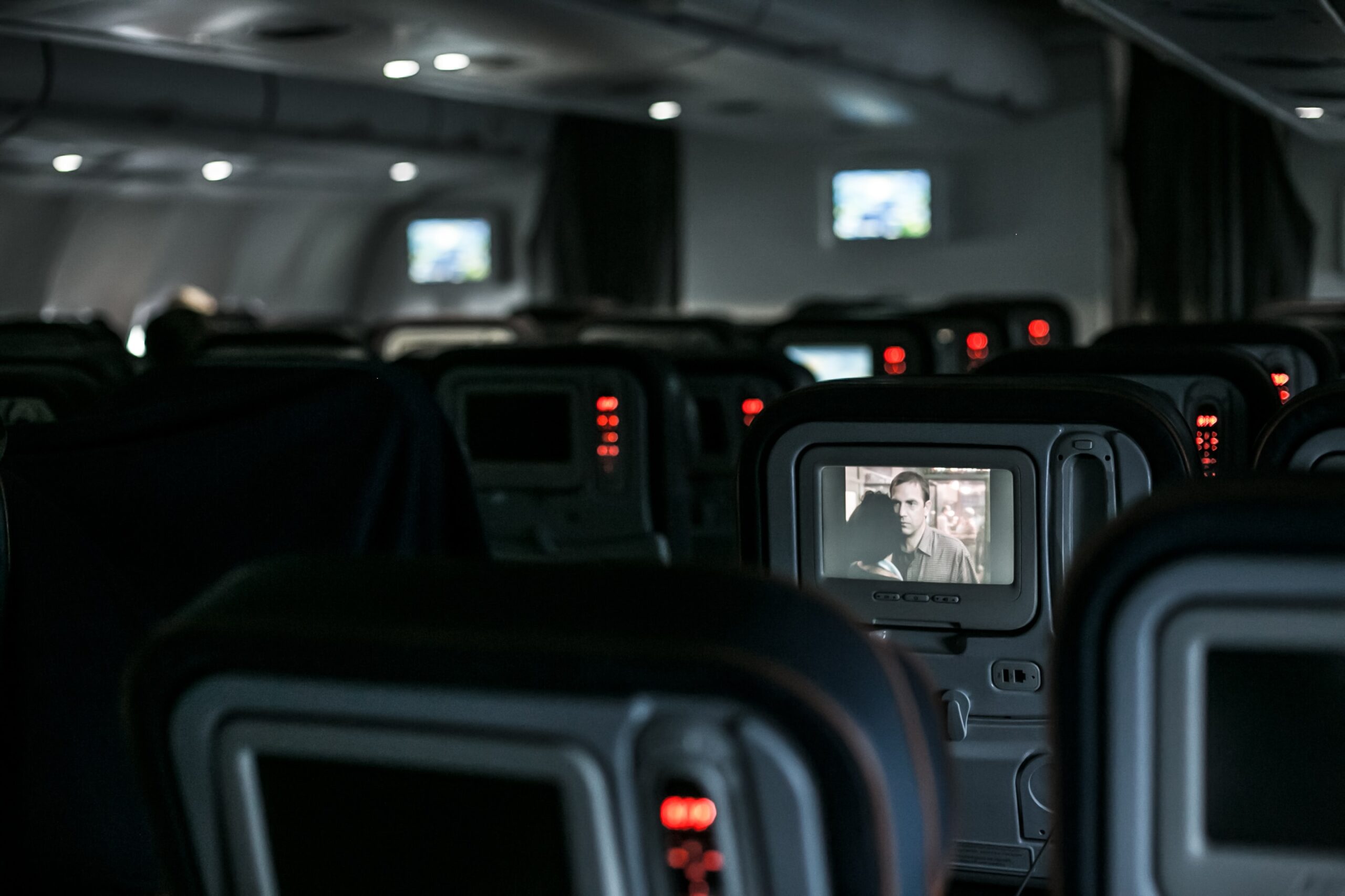 Airplane seats with TV: Photo by Alev Takil on Unsplash