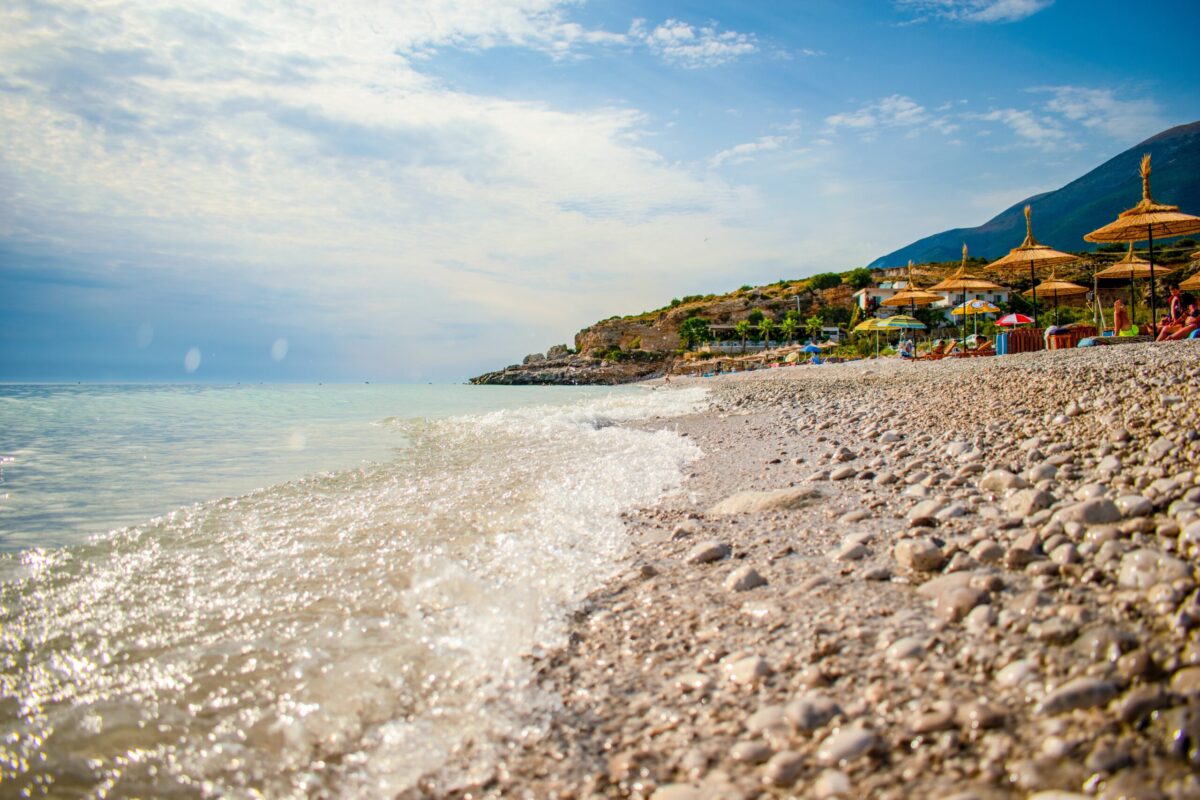 Albania Dhërmi, Rocky shore ocean beach: Photo by Gjoko Strezoski on Unsplash
