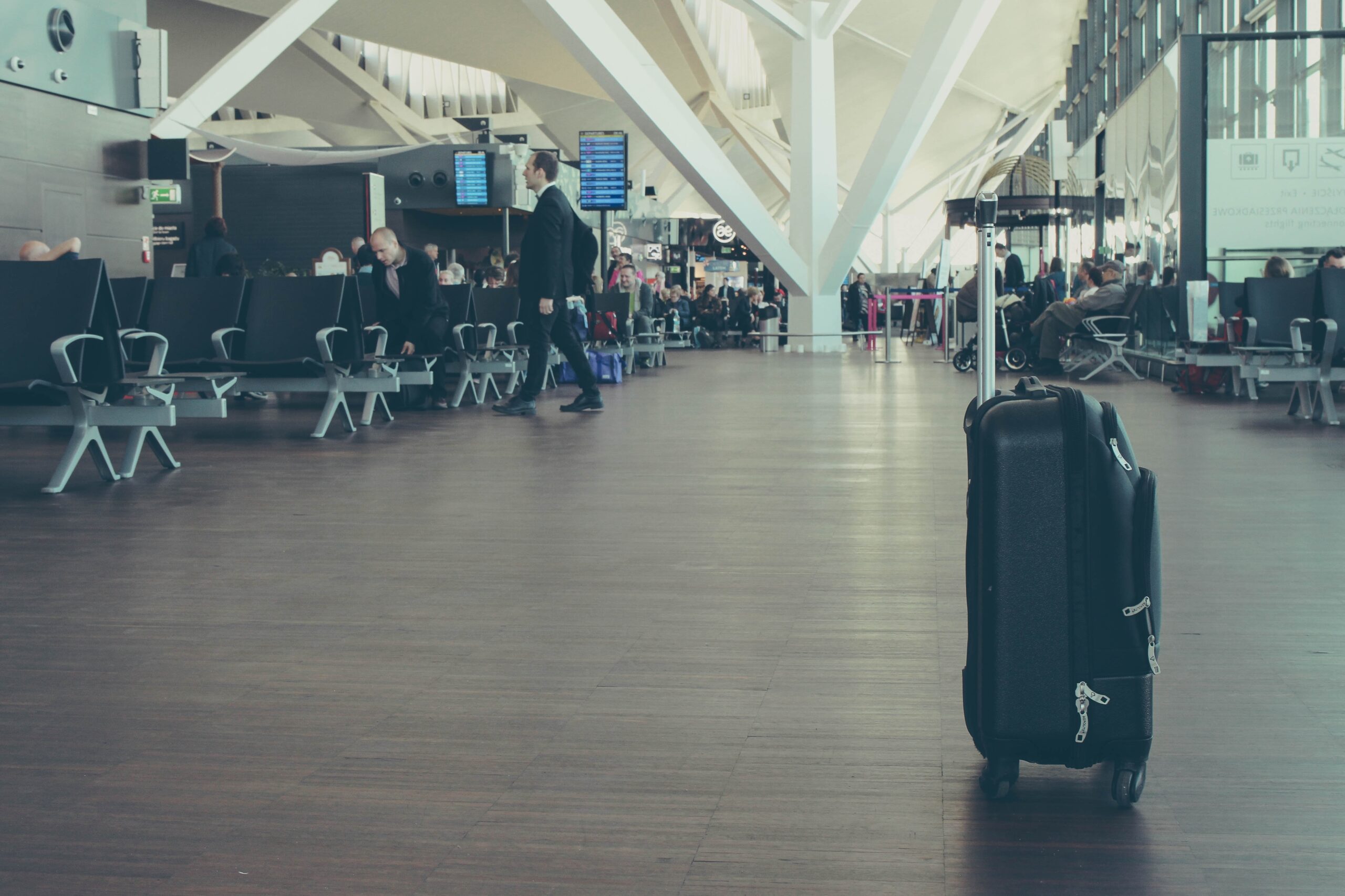 Suitcase in airport, Photo by Michał Parzuchowski on Unsplash