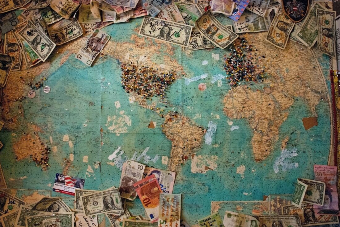 Travel fees money on map of the world: Photo by Christine Roy on Unsplash