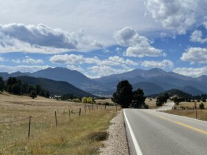 Road to Colorado Rocky Mountains with clouds and blue sky